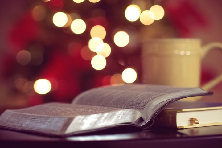 cbc mens group. picture of bibles and a coffe mug laying on a table with a blurry colorful background